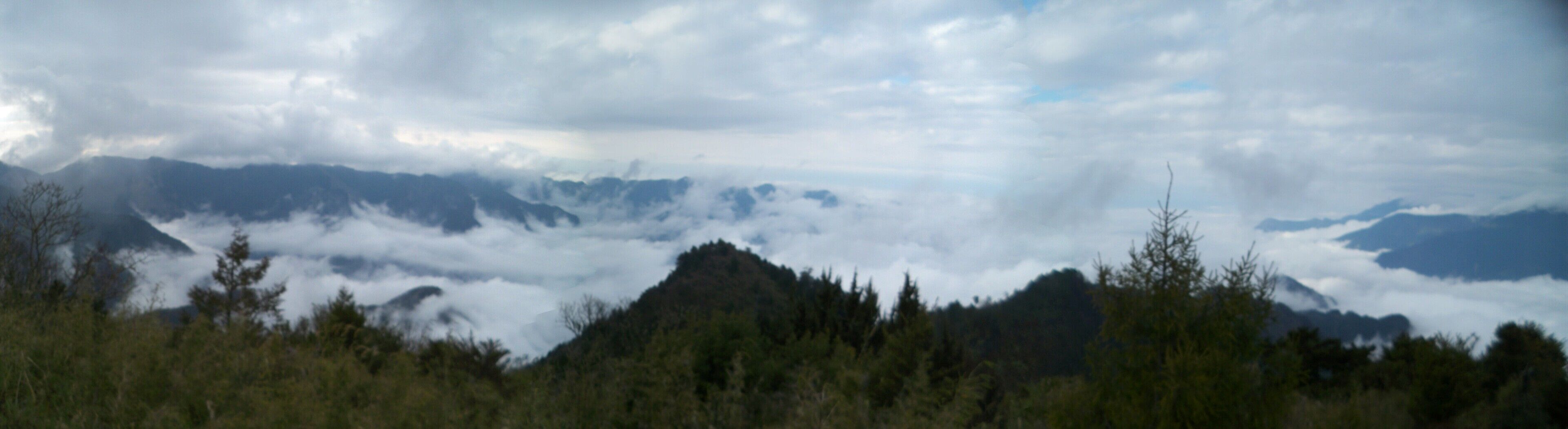 A mountain range with clouds below the peaks.