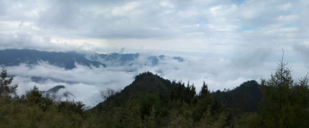 A mountain range with clouds below the peaks.