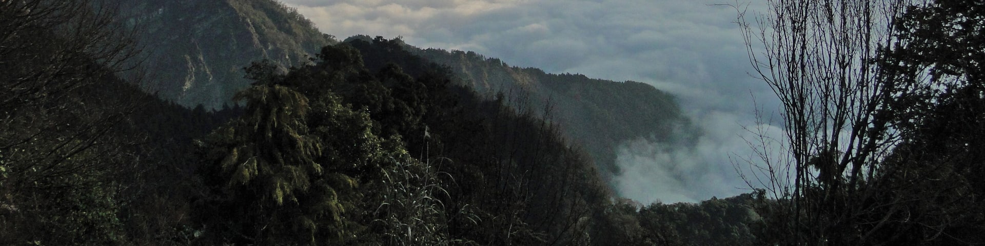 A mountain landscape with a valley of clouds below.