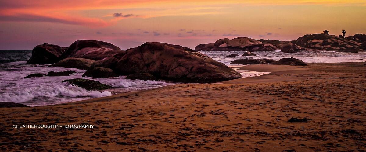 The sunrises and sunsets in Kirinda were breathtaking. The waves would crash into large boulders that jutted out of the sand. In the distance a tiny shack, or temple, can be seen sitting precariously on those boulders.