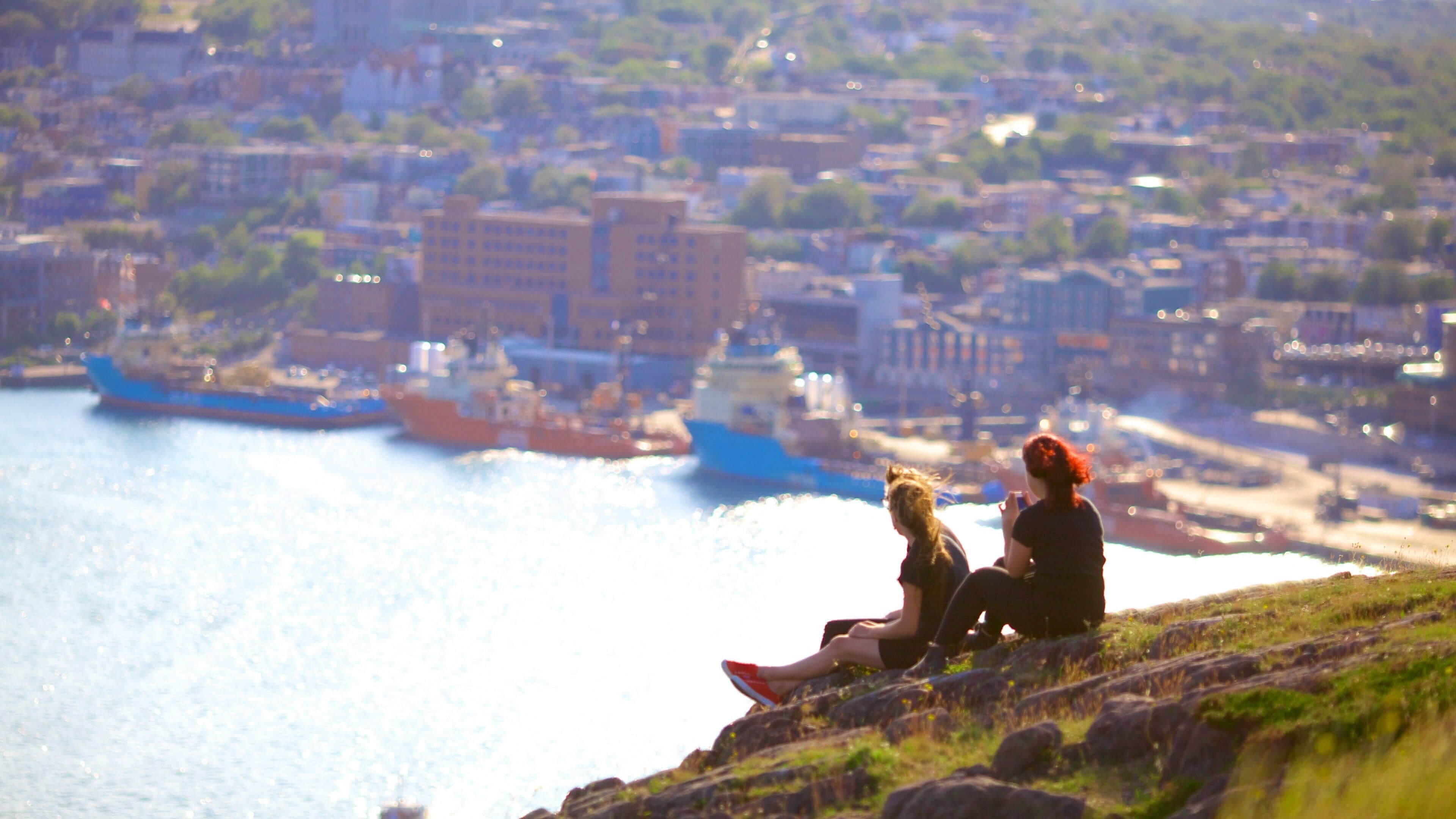 Signal Hill featuring general coastal views as well as a small group of people