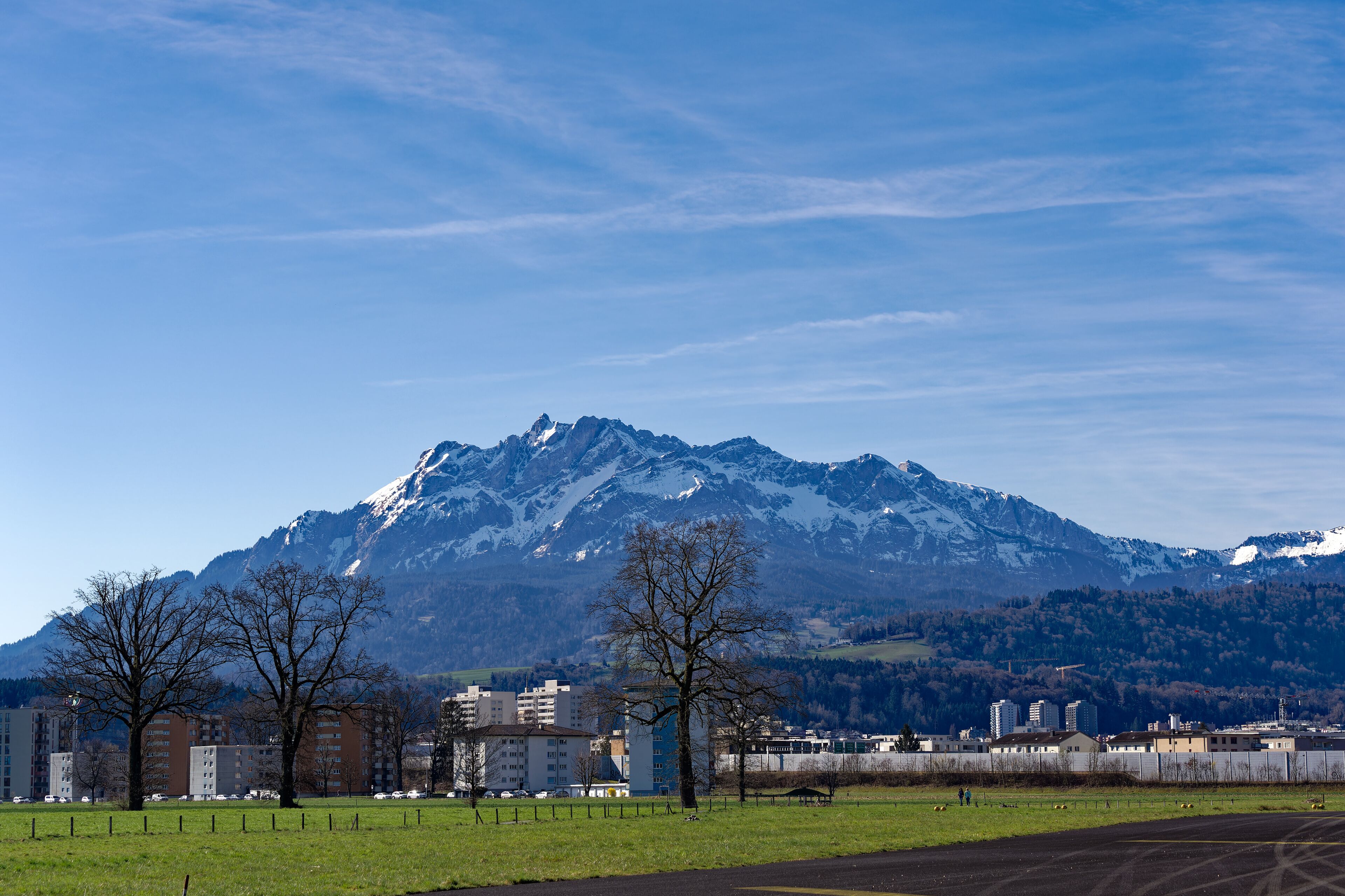 Scenic landscape and Swiss Alps with mount Pilatus seen from City of Emmen, Canton Lucerne, on a sunny spring day. Photo taken March 22nd, 2023, Emmen, Switzerland.