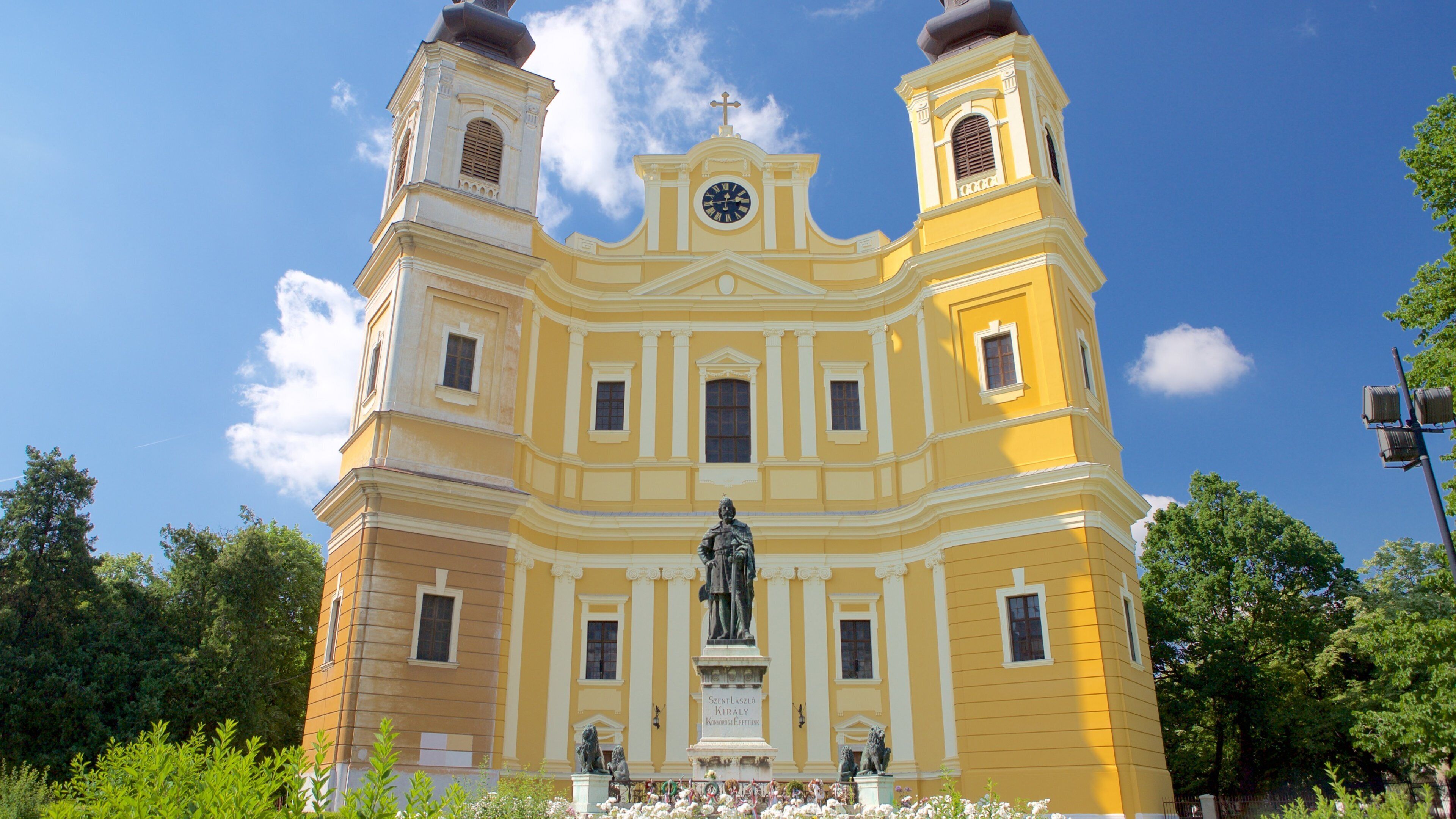 Roman Catholic Basilica featuring a house and a statue or sculpture