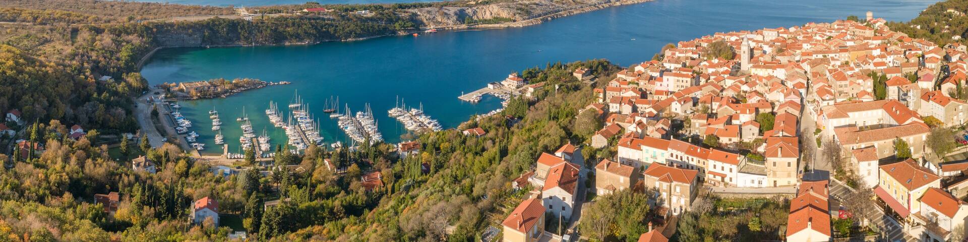 Panoramic aerial view of boats and houses on the shore of the bay in Omisalj, Croatia