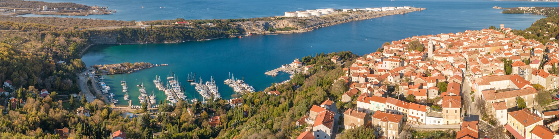 Panoramic aerial view of boats and houses on the shore of the bay in Omisalj, Croatia