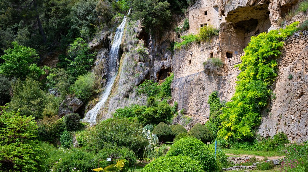 Aerial view of the beautiful Waterfall and Houses built into the cliff in the village of Villecroze France