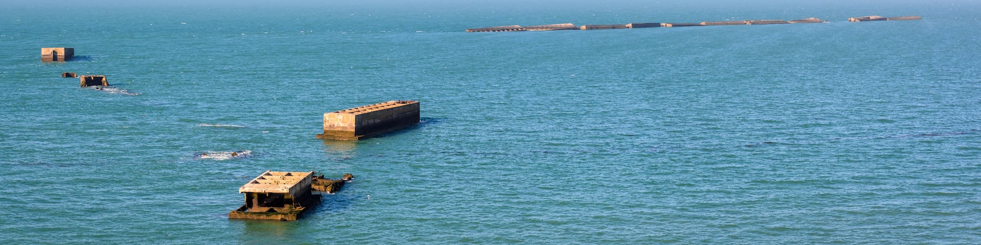 Remains of Phoenix caissons used to build the artificial Mulberry harbour on Gold Beach after the Normandy landings in World War II, seen from Cap Manvieux in Tracy-sur-Mer, France.