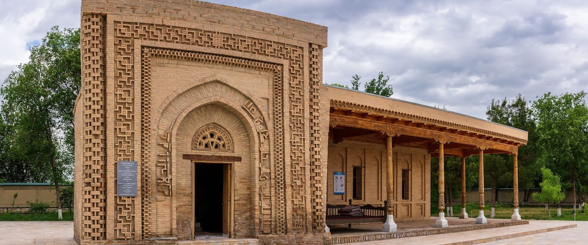 A historic building with intricate brickwork and a covered porch.