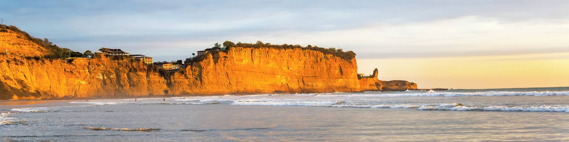Golden light falling on the cliffs near the beach town of Montanita, Ecuador