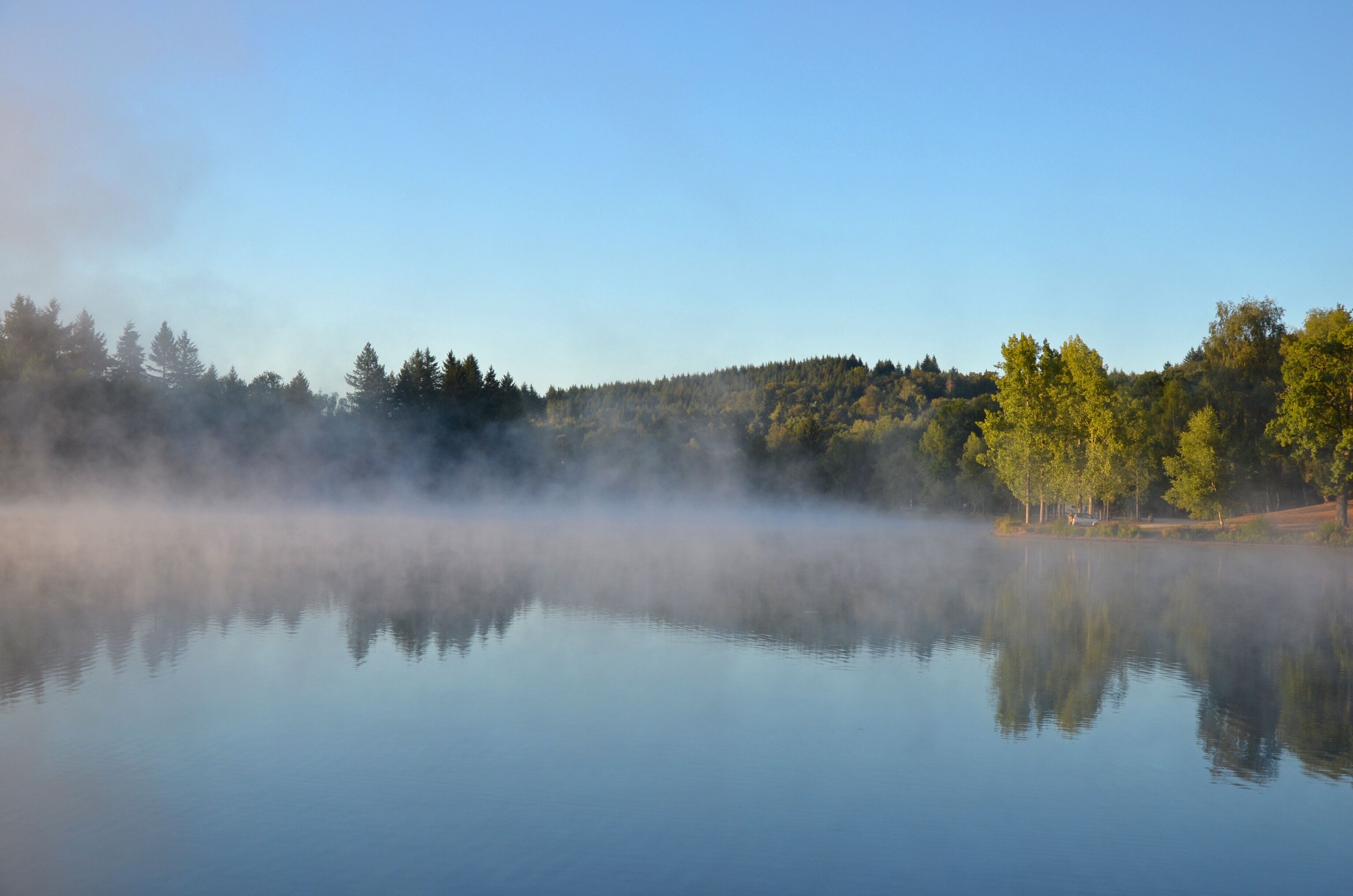 Rising fog at the Lake. Lac de Ponty, Ussel, France.