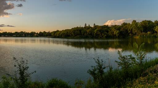 Clouds reflections and beautiful colors of a tranquil sunset at Lake Alice in Fergus Falls, Minnesota USA