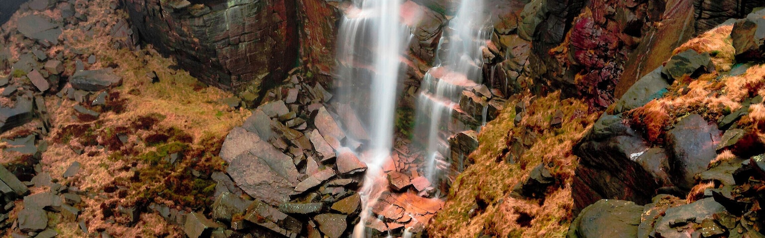 Kinder Downfall, where the River Kinder plummets 40 metres over the edge of Kinder Scout plateau. Reached on foot by an arduous walk from Hayfield of about 90 minutes.