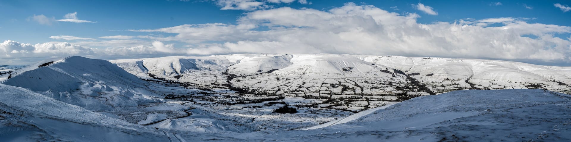 A snow-covered mountainous landscape with a clear sky.