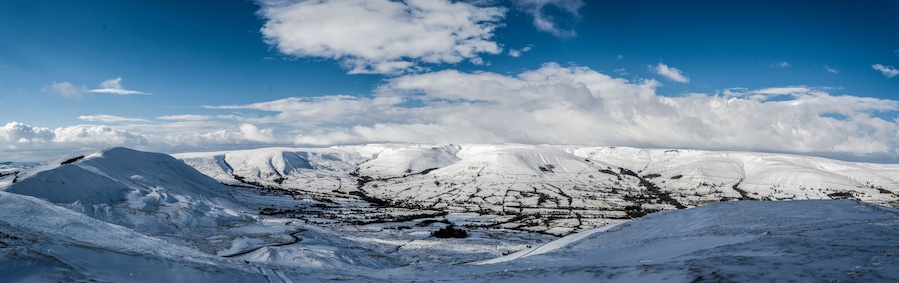 A snow-covered mountainous landscape with a clear sky.