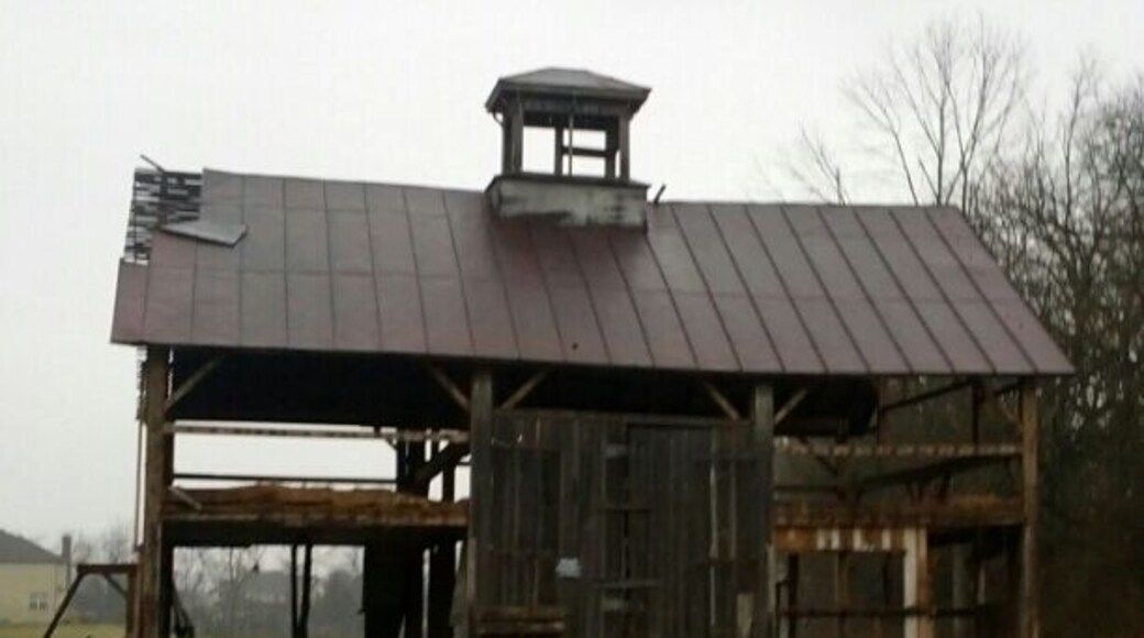 An abandoned barn well on its path to nonexistence.