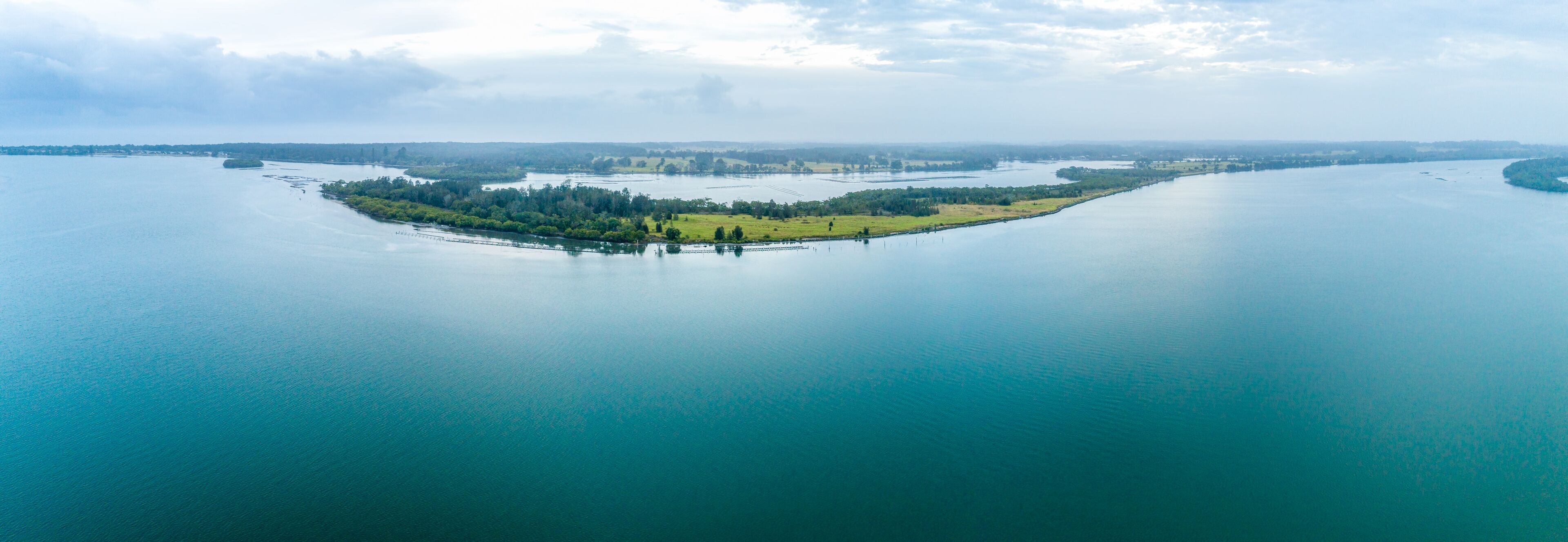Wide aerial panorama of Manning River with copy space. Harrington, New South Wales, Australia