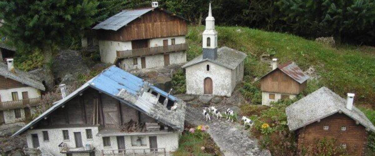 A model village with buildings, a church, and a winding path.