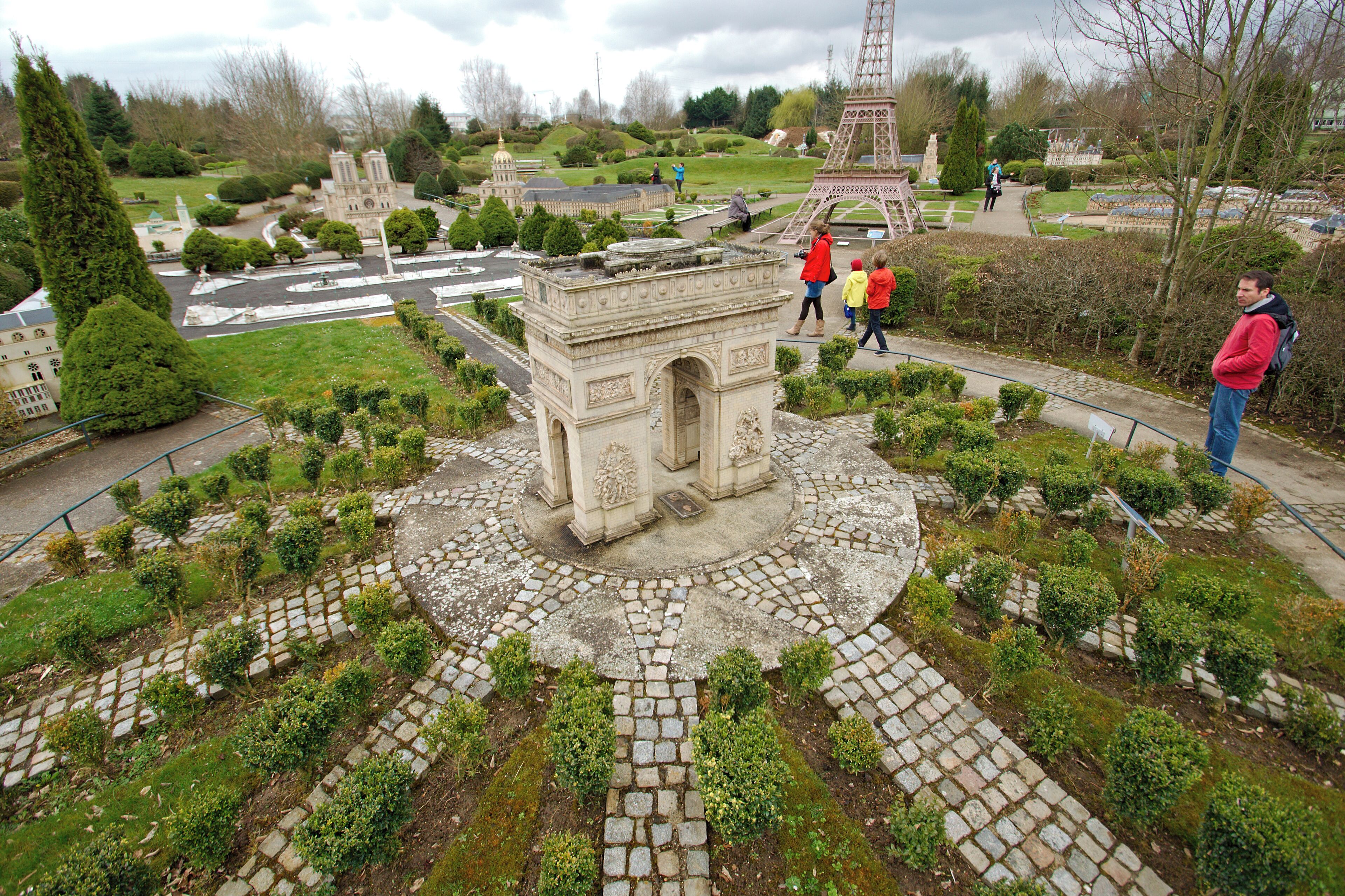 A model of the Eiffel Tower surrounded by a garden with a central monument.