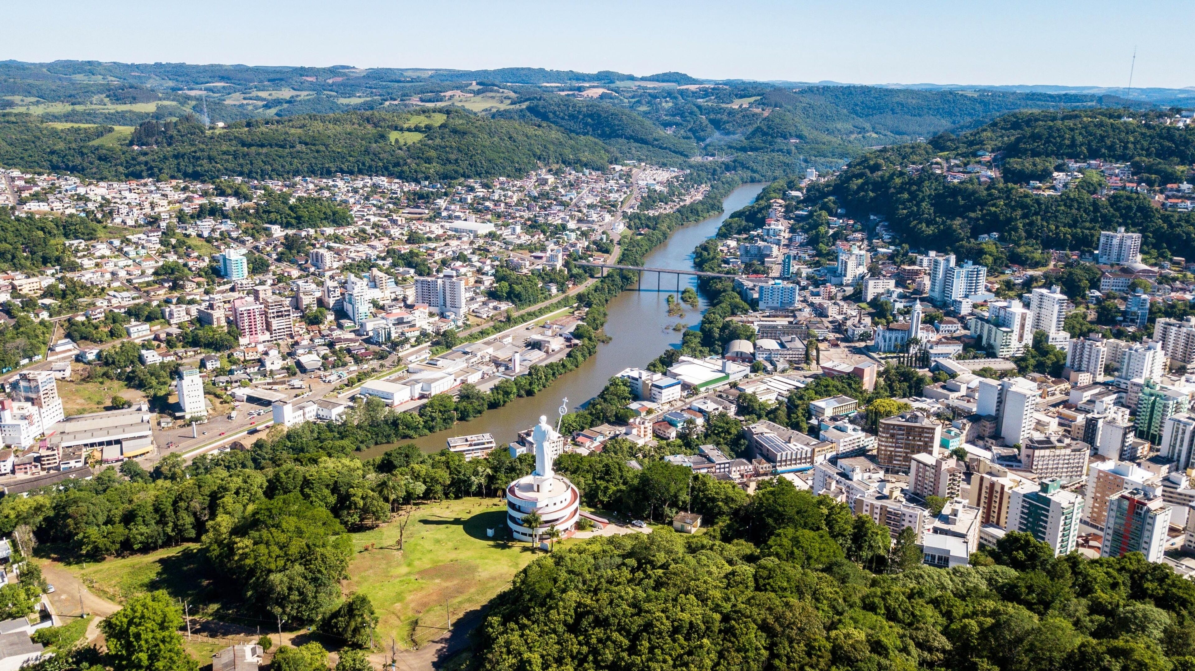 A cityscape with a river, a bridge, and a prominent white tower.