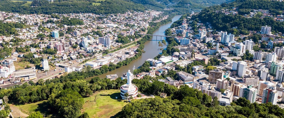 A cityscape with a river, a bridge, and a prominent white tower.