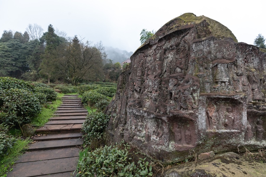 Carved Buddha statue in stone. Buddha statue in tea garden.