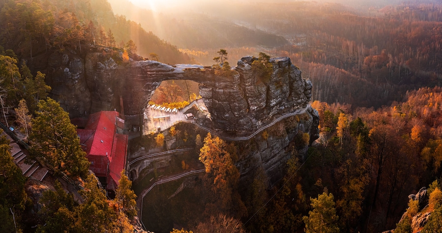 Hrensko, Czech Republic - Aerial panoramic view of the beautiful Pravcicka Brana (Pravcicka Gate) in Bohemian Switzerland National Park, the biggest natural arch in Europe with a warm autumn sunrise