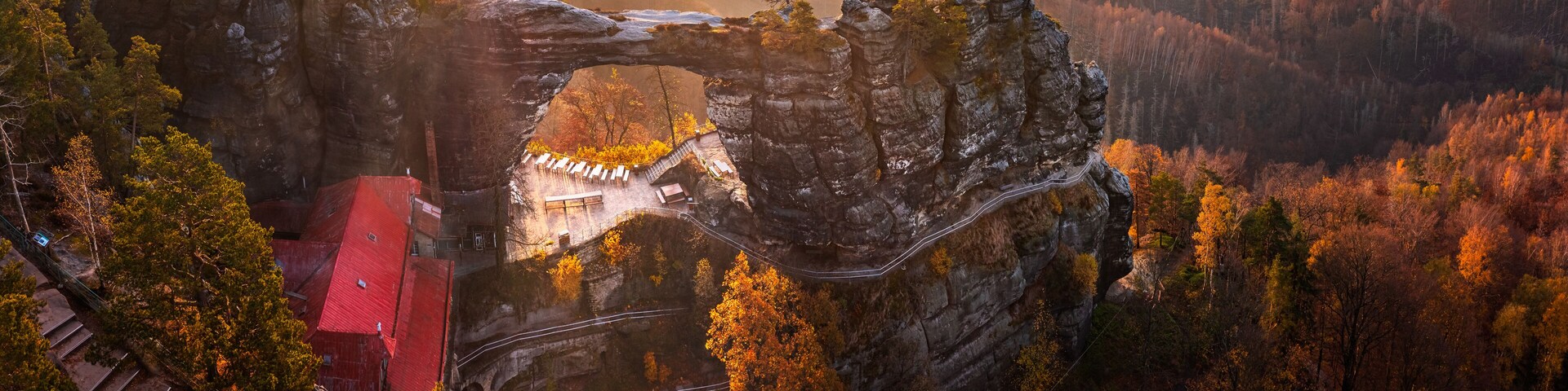 Hrensko, Czech Republic - Aerial panoramic view of the beautiful Pravcicka Brana (Pravcicka Gate) in Bohemian Switzerland National Park, the biggest natural arch in Europe with a warm autumn sunrise