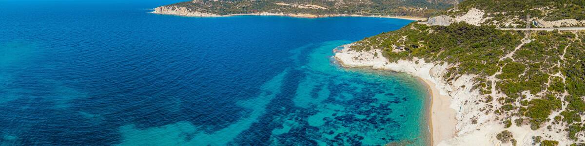 Breathtaking scenery of the Aegean sea with crystal clear turquoise water, white sand beaches and green hills