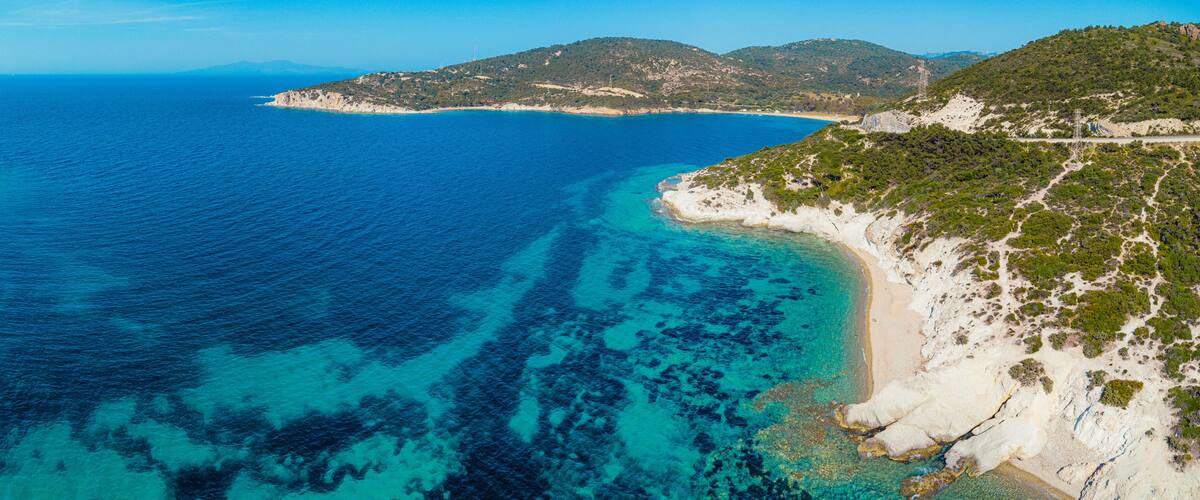 Breathtaking scenery of the Aegean sea with crystal clear turquoise water, white sand beaches and green hills