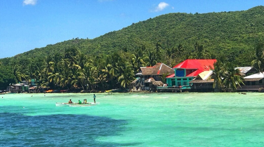 Local children play on fishing boats on the tropical island of Siquijor, Philippines. Siquijor has a rapidly growing tourism industry, with its beautiful white sandy beaches, extensive marine life & lush green rainforests. More and more travelers, especially from Korea, are turning away from Boracay, Palawan & Cebu and visiting this island 45 minute boat ride from the volcanic Negros Penninsula. Siquijor truly is paradise on earth! #LifeAtExpedia