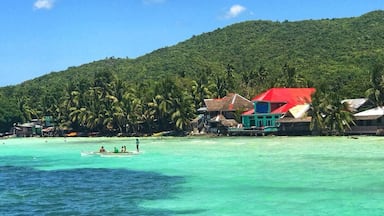 Local children play on fishing boats on the tropical island of Siquijor, Philippines. Siquijor has a rapidly growing tourism industry, with its beautiful white sandy beaches, extensive marine life & lush green rainforests. More and more travelers, especially from Korea, are turning away from Boracay, Palawan & Cebu and visiting this island 45 minute boat ride from the volcanic Negros Penninsula. Siquijor truly is paradise on earth! #LifeAtExpedia