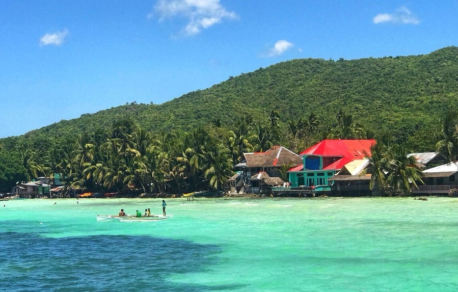 Local children play on fishing boats on the tropical island of Siquijor, Philippines. Siquijor has a rapidly growing tourism industry, with its beautiful white sandy beaches, extensive marine life & lush green rainforests. More and more travelers, especially from Korea, are turning away from Boracay, Palawan & Cebu and visiting this island 45 minute boat ride from the volcanic Negros Penninsula. Siquijor truly is paradise on earth! #LifeAtExpedia
