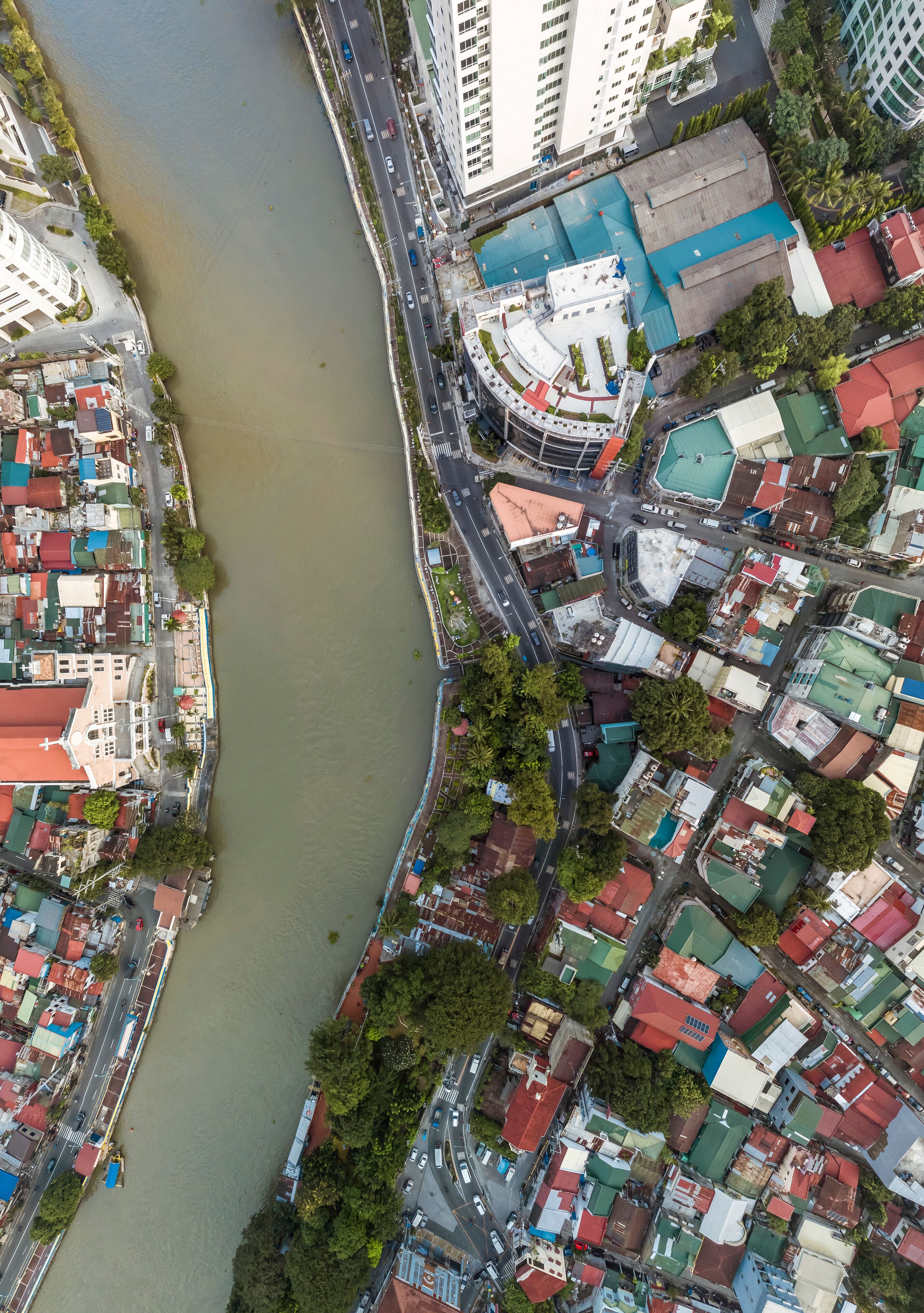 Top drone view of the Pasig River separating the cities of Mandaluyong and Makati, both part of Metro Manila.