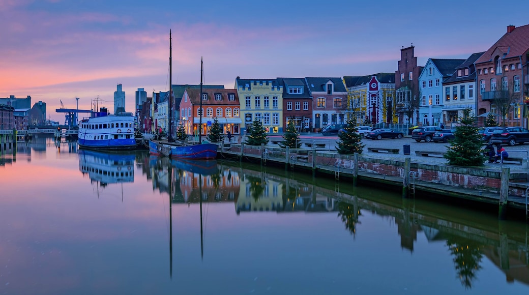 North Sea port city of Husum at Christmas time by sunset. "The gray town by the sea." View on Christmas port of Husum with Christmas trees and beautiful sunset.