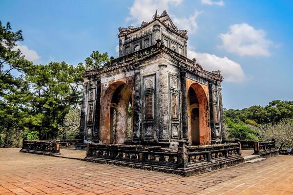 An ancient temple with ornate carvings and two large arches.