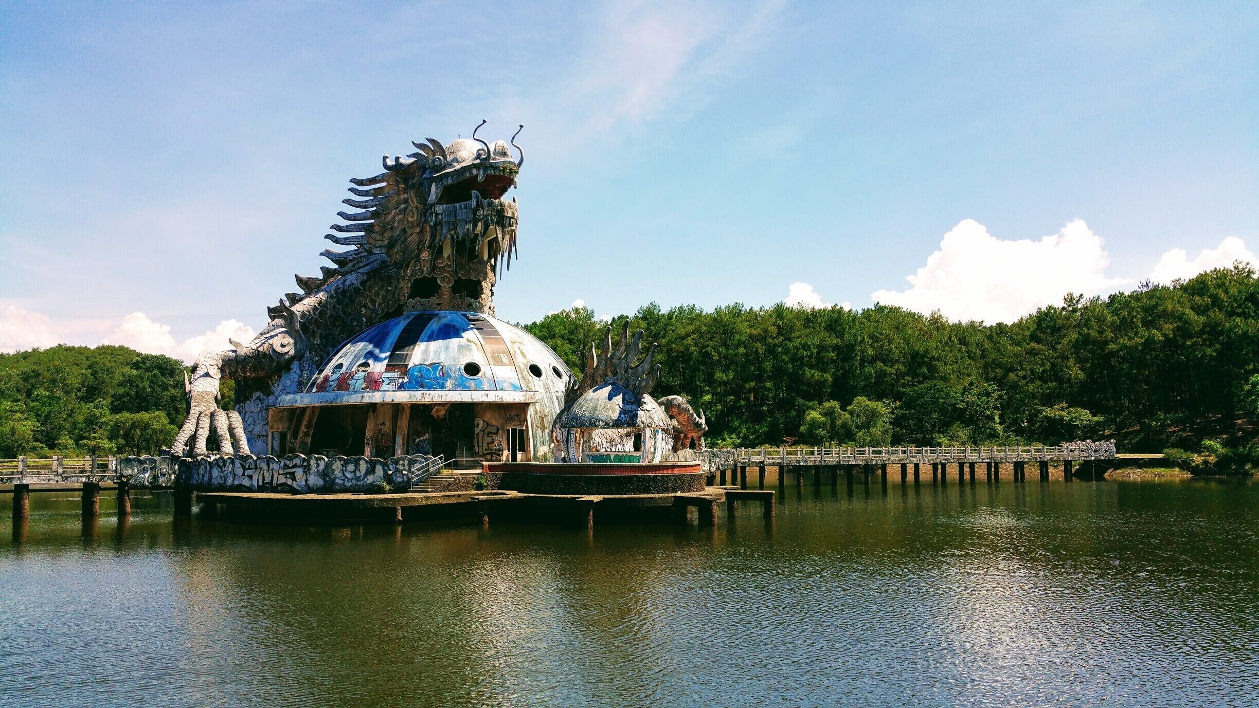 Abandoned Water Park, Thuy Tien Lake, Hue Vietnam. 

You can walk or bike around this a abandoned water park, that was opened in 2004 and cost around 3 million US dollar, then closed down not long after and left. There is a big lake with an an amphitheatre where shows would have been performed. The Dragon  (pictured) that you can still climb into the mouth to get a good view, flumes, slides, a kids play area and guest accommodation houses.    #packsandaplan #abandoned  

Check out our adventures and useful information  http://packsandaplan.com/