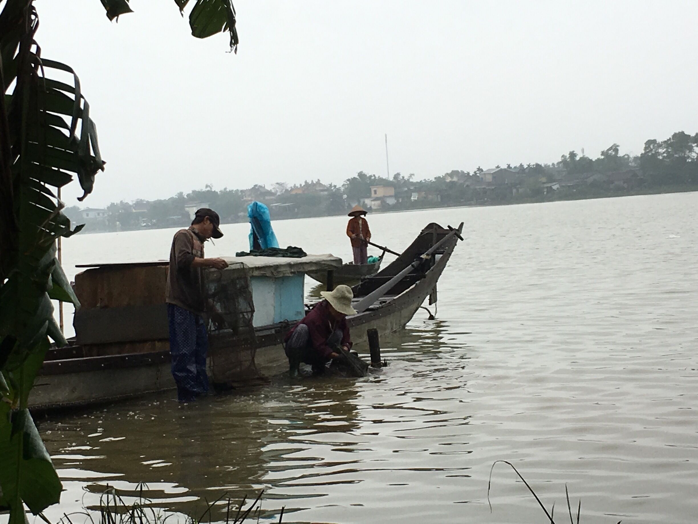 Villagers of Sinh Village washing their fishing nets