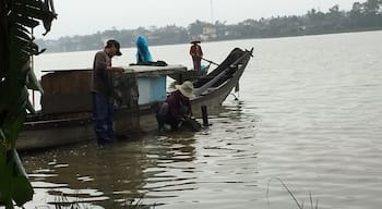 Villagers of Sinh Village washing their fishing nets