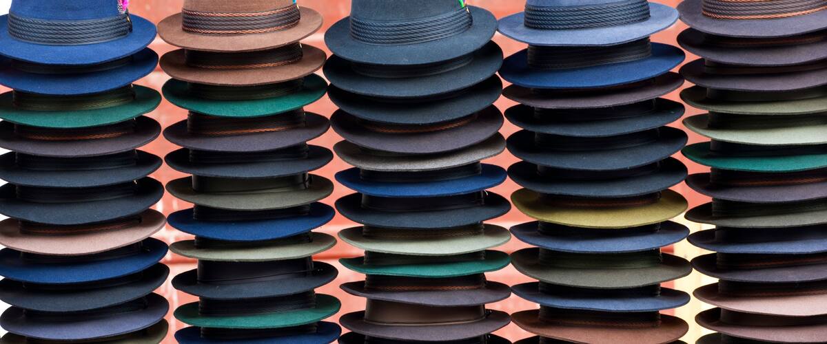 A collection of hats stacked in rows.