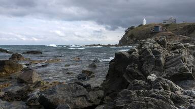 View of the rocky beach on a cloudy day