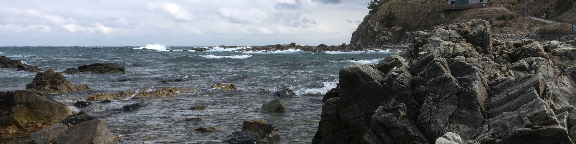 View of the rocky beach on a cloudy day