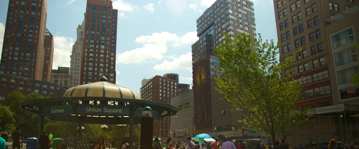 Union Square Park in New York showcases vibrant activity and urban architecture under a sunny sky