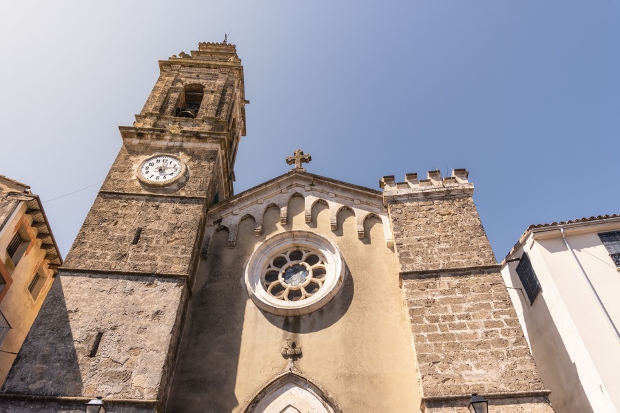 Une église dotée d’un clocher, d’une rosace et d’une croix au sommet.