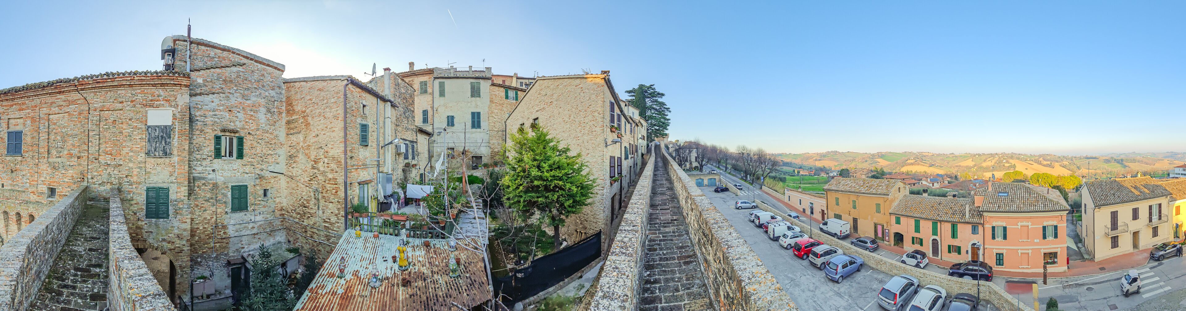 A historic town with stone buildings, narrow streets, and a canal.