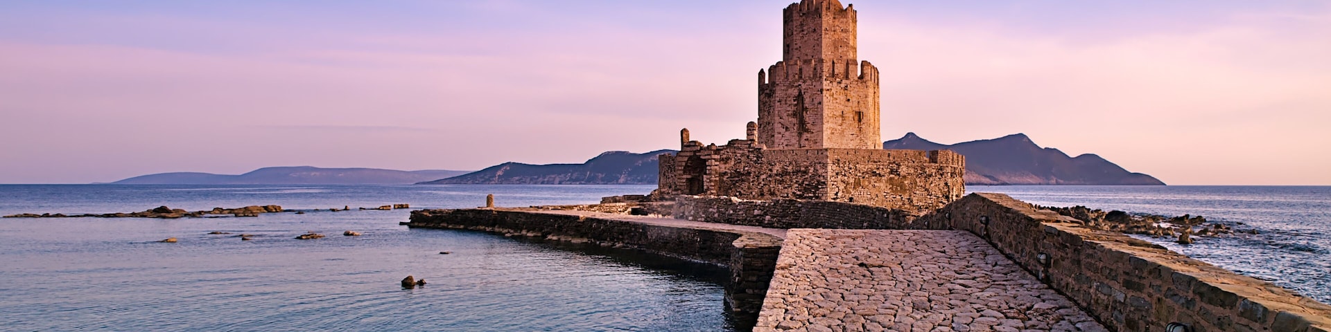 Impressive three-tiered watchtower, Venetian fort castle of Methoni, Greece at sunset time.