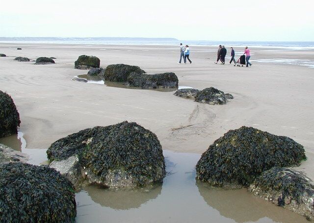 Middle Cliff Beach, Speeton Sands Heavily eroded anti-tank blocks on the beach below Reighton Sands Holiday Village, looking north-northwest towards Filey Brigg.