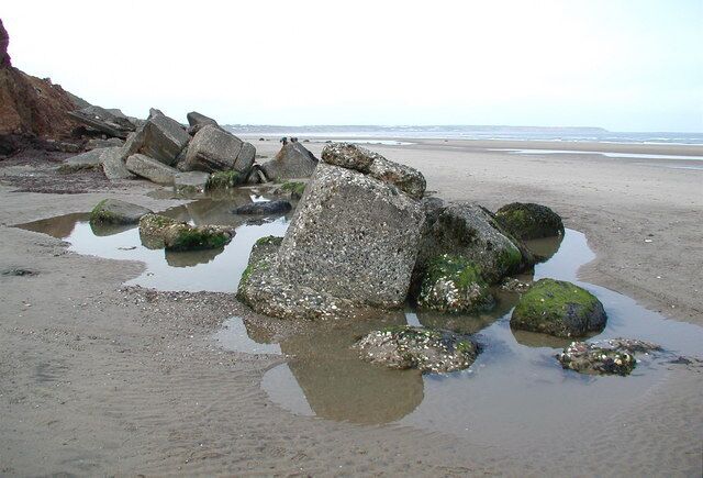 Reighton Gap Heavily eroded World War II concrete defences on the beach at Reighton Gap, looking northwest towards Filey Brigg.