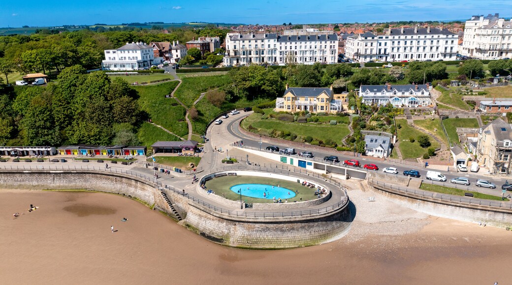 Aerial photo of the beautiful town of Filey in the UK, showing the beach front and open air public swimming pool on a sunny summers day
