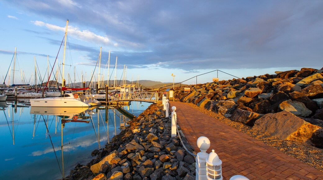Coral Sea Marina featuring a sunset and a bay or harbor