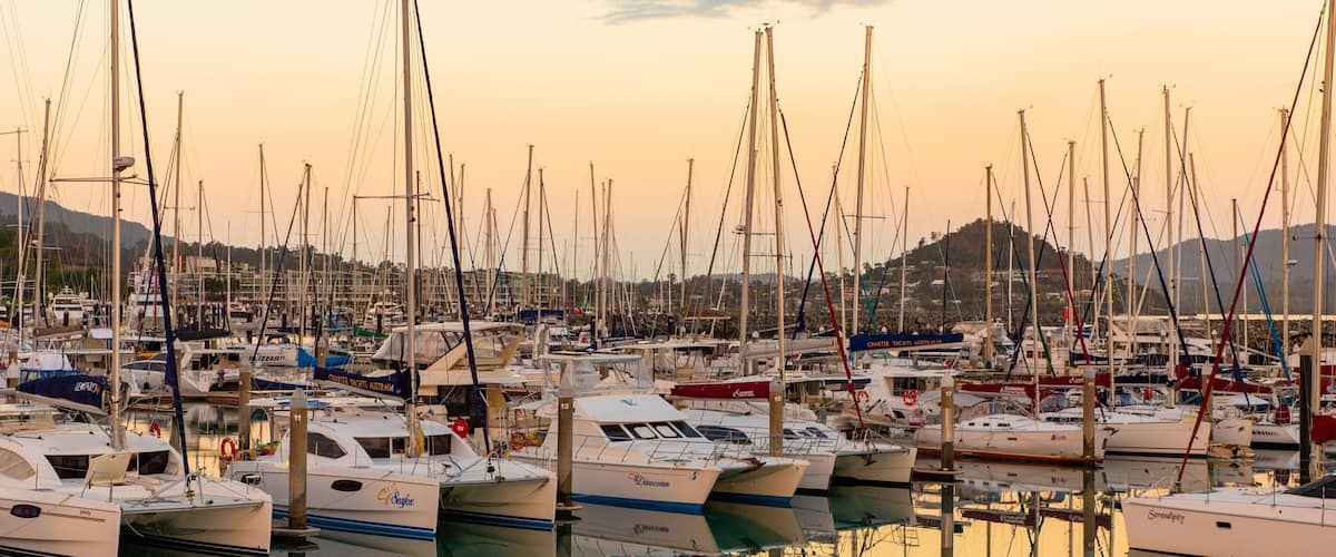 Coral Sea Marina featuring a bay or harbor and a sunset